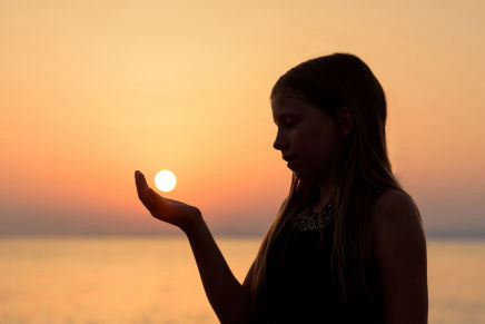 Child holding ball of light - biophotons